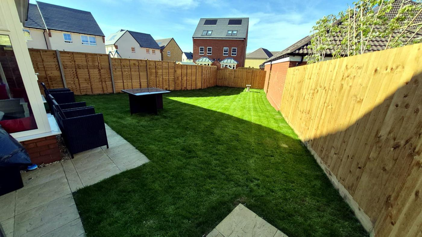 New turf, patio and fencing in a new-build garden